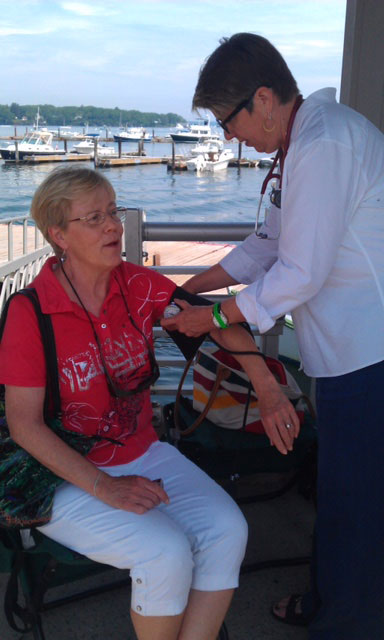 Kitty Gilbert, FNP, checks blood pressure